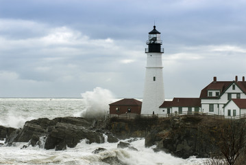 Fototapeta na wymiar Waves Crash Next to Oldest Lighthouse in Maine