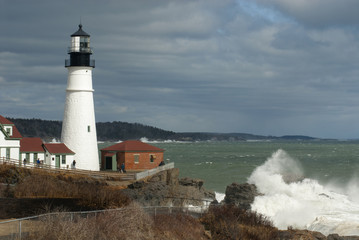 Huge Waves Break by Sunlit Portland Head Lighthouse in Maine