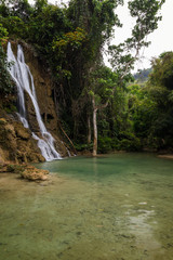 View of idyllic Khoun Moung Keo Waterfall, pond and lush trees near Luang Prabang in Laos.