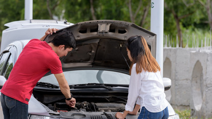 Wrecked road trip, transport, travel, technology and people concept - close up of Couples are concerned when their car breaks down.