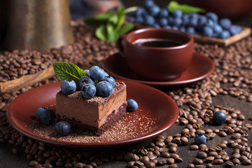 Chocolate cake with blueberries and mint .