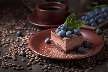 Chocolate cake with blueberries and mint .