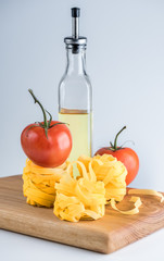 Fettuccine pasta with tomato on a cutting board