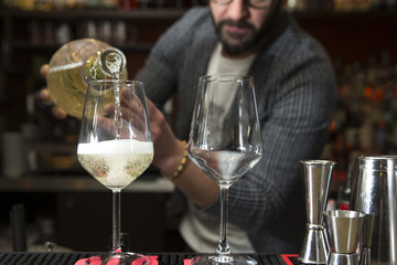 barman pouring prosecco
