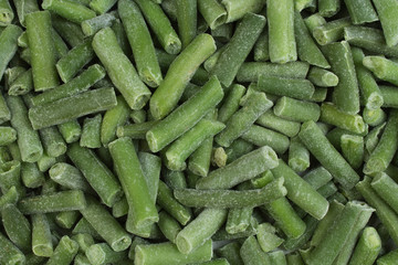 frozen chopped asparagus beans. top view. background green wax beans.