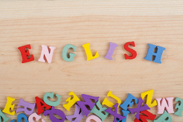 English word on wooden background composed from colorful abc alphabet block wooden letters, copy space for ad text. Learning english concept.