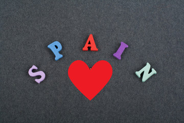 I love SPANISH word on black board background composed from colorful abc alphabet block wooden letters, copy space for ad text. Learning english concept.