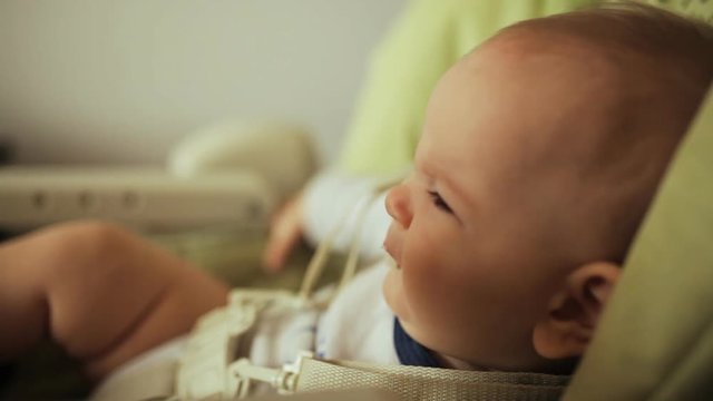 a small child is fed porridge