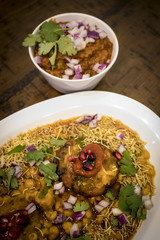 Ragda Patties Indian Dish with Bowl of Bhaji on a Dark Wood Table