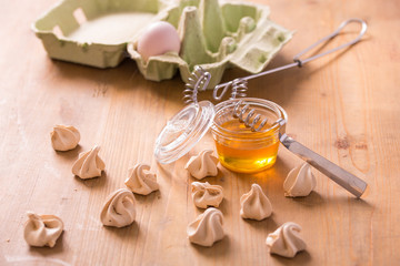 Fototapeta na wymiar Little honey meringues on a wooden table
