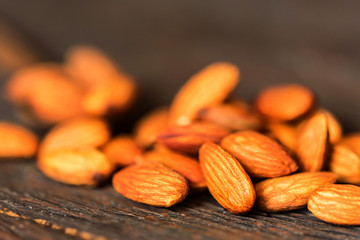 Almonds on dark wooden surface close