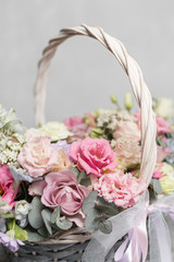 Beautiful flower composition a bouquet in a wicker basket. Floristry concept. Spring colors