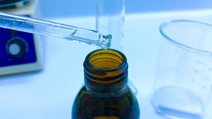 Manipulating a dropper bottle in the chemistry lab

