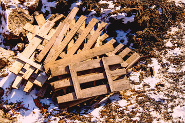 construction debris wooden planks on the ground with snow