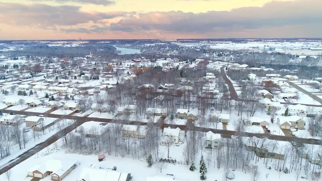 Scenic small town Wisconsin under a fresh layer of snow, aerial view.
