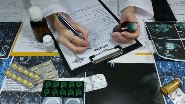woman doctor fills a medical form