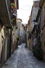 Narrow steep street in small village located in the Park of Serra de Montsant, Spain