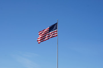The American flag floats in the air proudly.                              