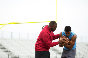 Coach training a high school athlete.