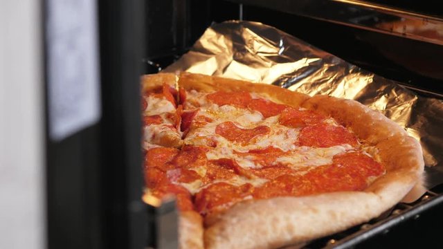 Pizza cooking in modern oven at home