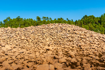 grey wall of round stones.