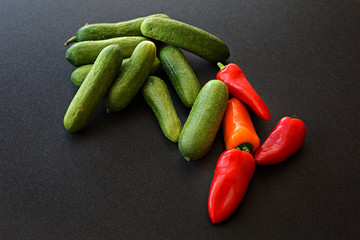 Fresh cucumber and tomato vegetables on black background