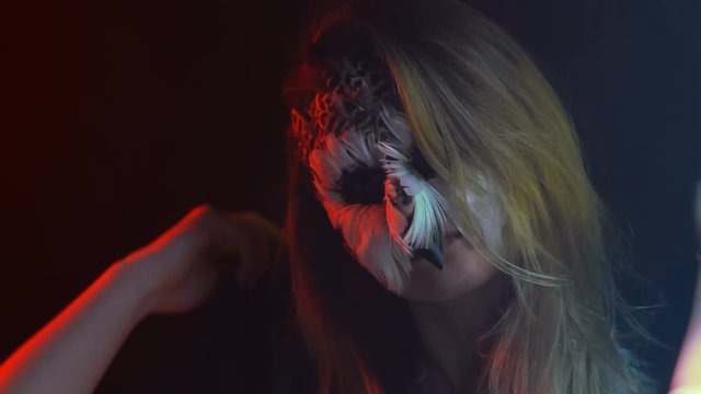 Close-up, Beautiful Girl with Owl's Face on the Face Removes and Again Dresses on the Head Black Hood