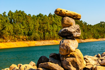 Fototapeta premium Stone pyramid on a floating river.