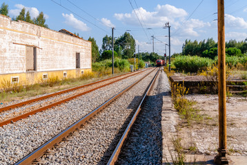 Train passing platform. A Diesel train seen speeding past a platform.