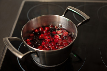 Compote with berries in a saucepan on the stove