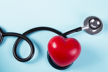 Stethoscope with red heart on a blue background. Medical concept