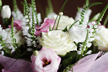 Delicate  beautiful wedding bouquet with white roses and pink eustomas