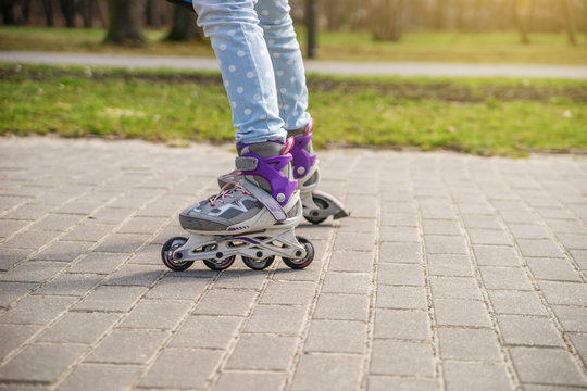 Girl on roller skates in the Park.