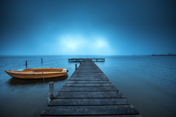 Fototapeta premium Small Dock and Boat at the lake