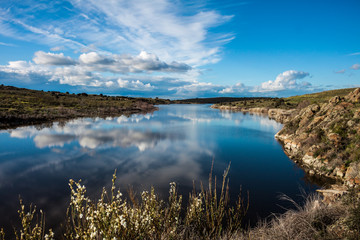 landscape with clouds and reflections in the river