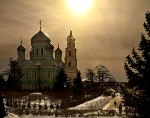 Domes at sunset. Trinity Cathedral of the monastery of St. Seraphim of Sarov (Russia) in the rays of the setting sun
