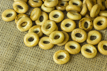 Small tasty and fresh rolls lying on burlap.