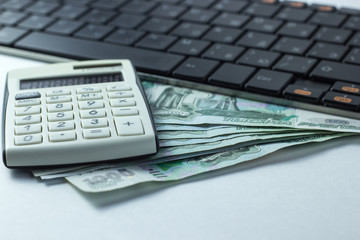 Money lying on the keyboard, a concept for buying new computer