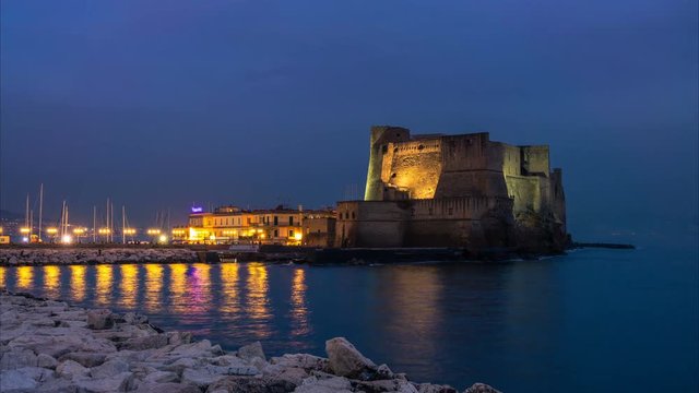Naples, Italy. Castel Dell'ovo, Egg Castle,  Campania. View from the shore in the evening. Time lapse