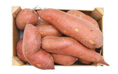 Bunch of sweet potatoes in a wooden crate on a white background