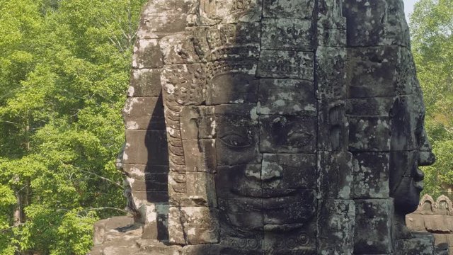 Image of Buddha recognisable in ruins of Angkor Wat temple