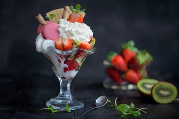 softijs with strawberries, kiwi and cream. ice-cream with fruits in a cube