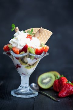 softijs with strawberries, kiwi and cream. ice-cream with fruits in a cube