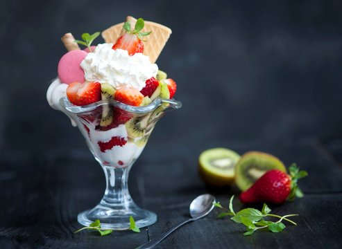 softijs with strawberries, kiwi and cream. ice-cream with fruits in a cube