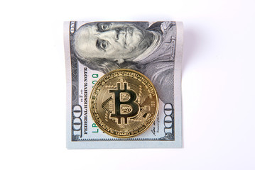 Cryptocurrency physical golden bitcoin coin on us dollars close up