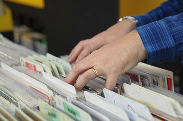 Unidentified man searching for records in a record store