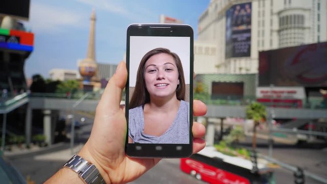 Video chatting with a woman on a smartphone while visiting Las Vegas, Nevada.  	