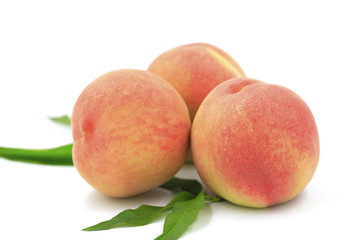 Fresh peaches on a white background
