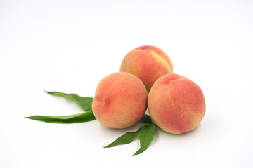 Fresh peaches on a white background