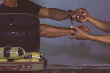 Law and police concept. Arrest drug trafficker with handcuffs.